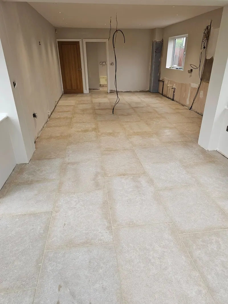 Limestone floor tiles laid across a kitchen diner and utility area in Swansea