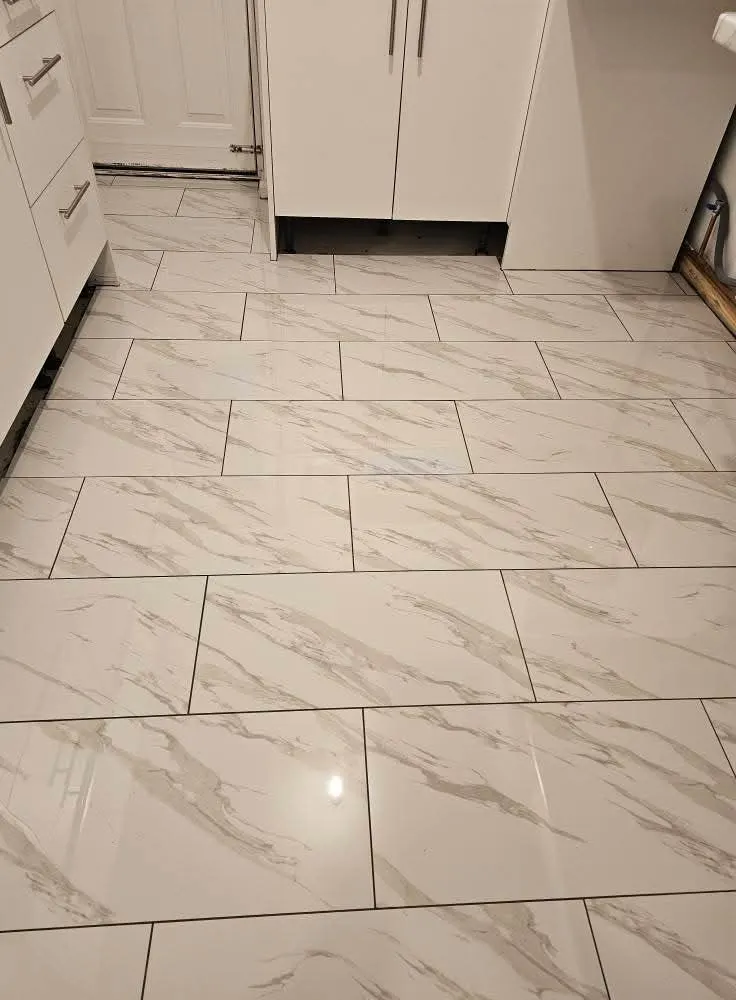 White marble-effect floor tiles laid in a kitchen