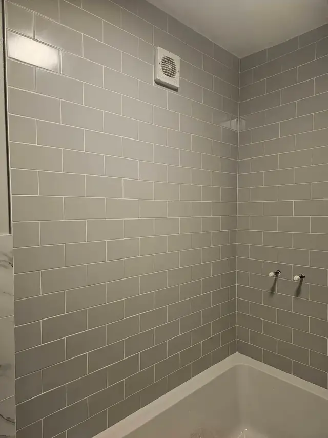 Bathroom tiling in Swansea: grey brick white grout