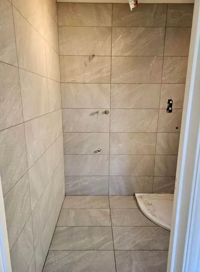 Bathroom tiling in Swansea: grey big tiles shower