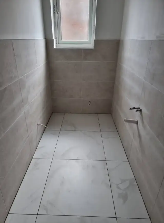 Bathroom tiling in Swansea: white beige half