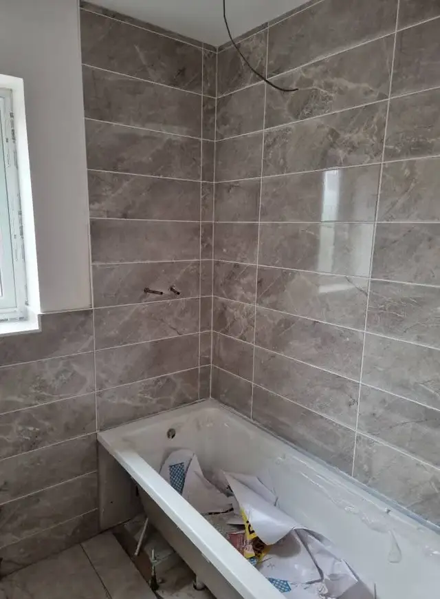 Bathroom tiling in Swansea: grey tile white grout