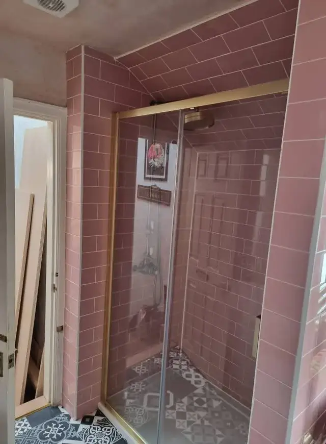 Pink brick-effect tiled shower enclosure