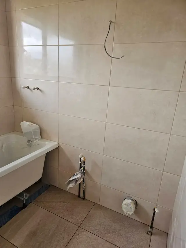 Bathroom tiling in Swansea: beige tiles bath