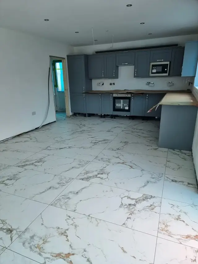 White marble-effect floor tiles in an open-plan kitchen