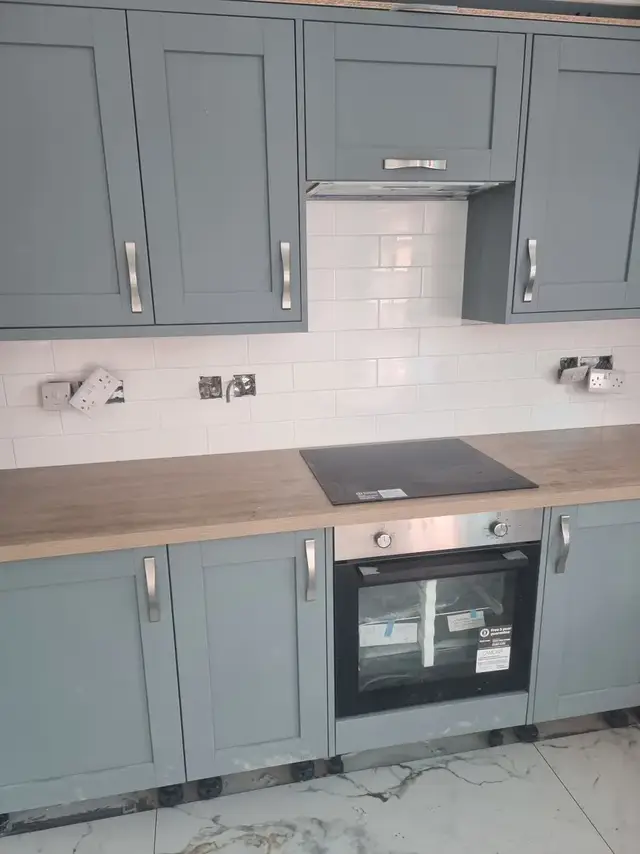 Blue and white brick-effect splashback in a grey kitchen